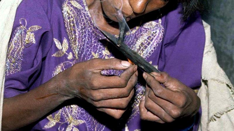 An Indian woman in New Delhi smokes a crude form of heroin. NGOs estimate India has 7 to 9 million addicts and almost all are aged between 15 and 35 [Reuters]