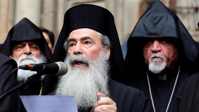 Greek Orthodox Patriarch of Jerusalem, Theophilos III, speaks during a news conference with other church leaders in front of the closed doors of the church [Reuters/Amir Cohen]