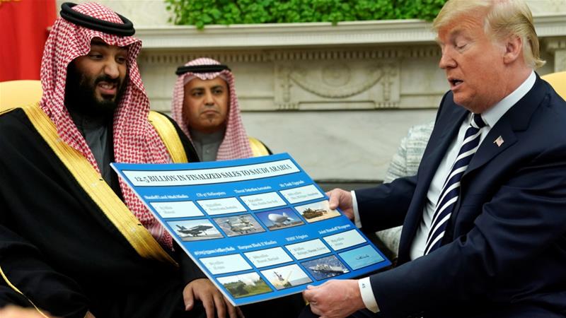 US President Donald Trump holds a chart of military hardware sales as he welcomes Saudi Arabia's Crown Prince Mohammed bin Salman in the White House on March 20, 2018 [Jonathan Ernst/Reuters]