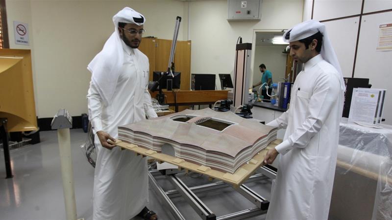 Mechanical engineers show a 3d-printed model of Qatar's Al Bayt stadium, which will host a World Cup semi-final in 2022, at a laboratory at Qatar University in Doha, Qatar [braheem Al Omari/Reuters]