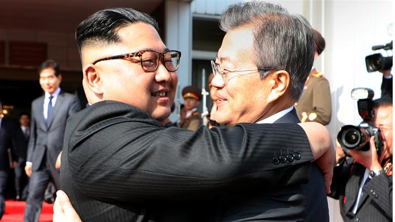 Kim Jong-un embraces South Korean President Moon Jae-in after their surprise meeting on Saturday [Presidential Blue House via Reuters]