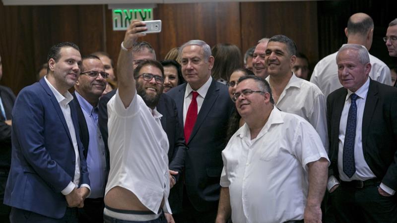 Knesset member Oren Hazan takes a selfie with Israel's Prime Minister Benjamin Netanyahu after a Knesset session that passed the 'nation-state' bill in Jerusalem on July 19 [AP Photo/Olivier Fitoussi]