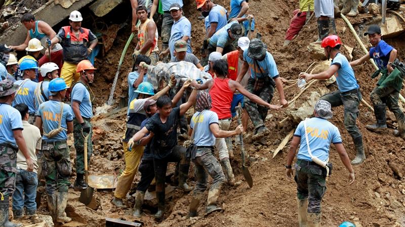 Dozens of people were thought to have been trapped when part of a mountain slope collapsed in a remote village in Itogon [Harley Palangchao/Reuters]