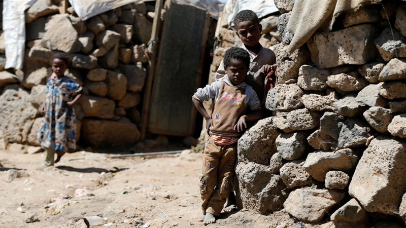 Children stand near their hut at a makeshift camp for internally displaced people near Sanaa last month [Khaled Abdullah/Reuters]