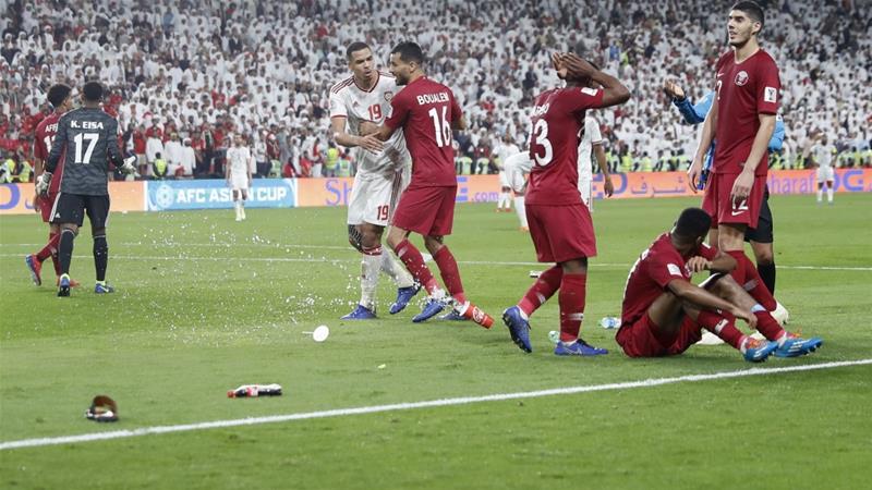 Qatar's players were pelted with shoes and bottles during the match on Tuesday [Hassan Ammar/AP]