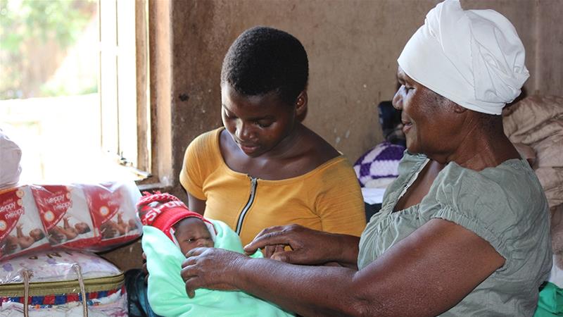 New mother Vimbai Mhere gave birth to her daughter in a 'back yard' clinic run by midwife Esther Zinyoro [File: Chris Muronzi/Al Jazeera]