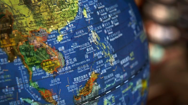 A globe shows the islands on the South China Sea with nine-dash line claims under Chinese territory. In a major policy reversal, the US on Monday rejected nearly all of China's claims in the area [File Andy Wong/AP Photo]