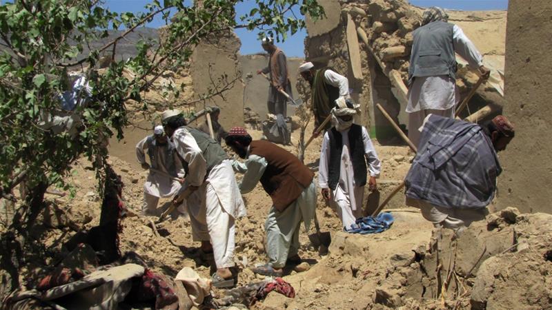 Afghan villagers search for the bodies of people killed in a NATO air attack in Logar Province in 2012 [File: Sabawoon Amarkhil/AFP]