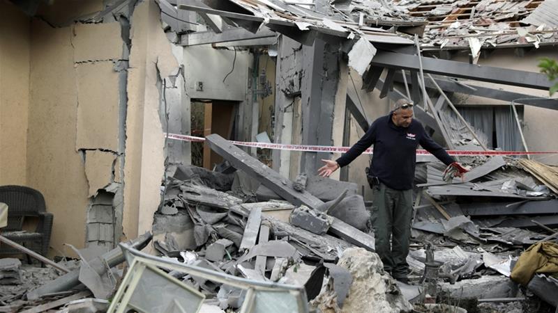 A police sapper inspects a damaged house that was hit by a rocket north of Tel Aviv [Ammar Awad/Reuters]