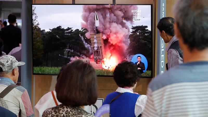 People in South Korea watch TV news reports showing file pictures on North Korea's latest missile launch.  [Ahn Young-joon/AP Photo]