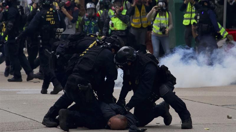 Clashes cut short Hong Kong rally as police officers are attacked