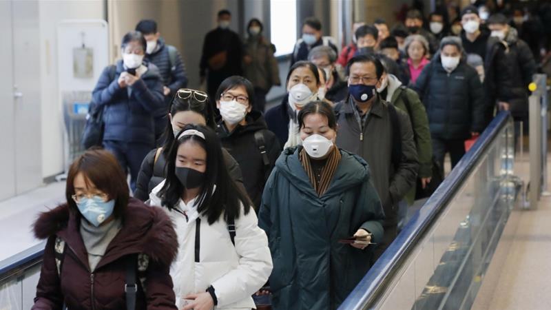 Passengers from Wuhan arrive at Narita Airport in Chiba, Japan on Thursday [Reuters]