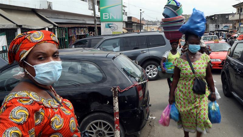 Women walk in the streets of Abidjan, Ivory Coast following the outbreak of coronavirus (COVID-19) [Reuters]