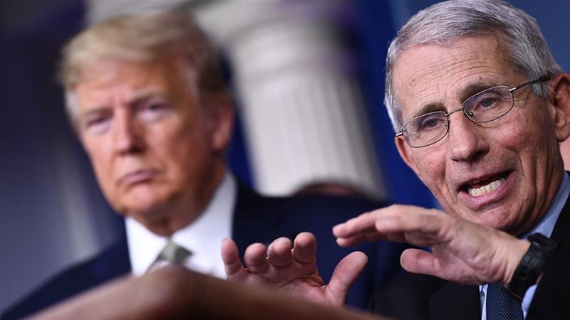 Dr Anthony Fauci speaking as US President Donald Trump listens during the daily press briefing on the Coronavirus pandemic at the White House [File: Brendan Smialowski/AFP] 