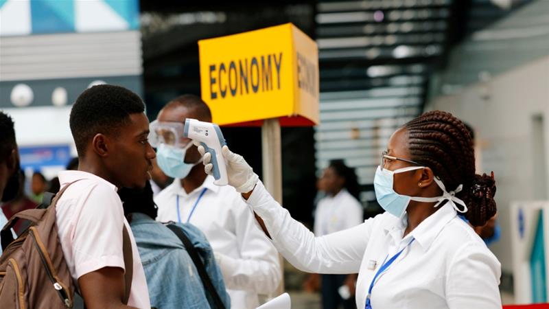 A health worker checks the temperature of a traveller as part of the coronavirus screening procedure at the Kotoka Airport in Accra, Ghana on January 30, 2020 [File: Reuters/Francis Kokoroko]