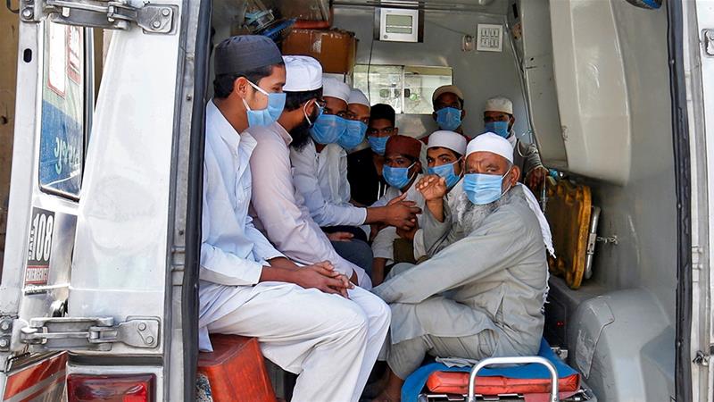 Men, who according to officials visited three Muslim missionary gatherings including in New Delhi's Nizamuddin area, sit in an ambulance that will take them to a quarantine facility, on April 3 [Amit Dave/Reuters]