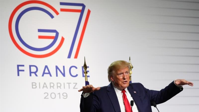 Trump talks to the members of the press at the G7 Summit in France in 2019 [File: Andrew Harnik/AP]