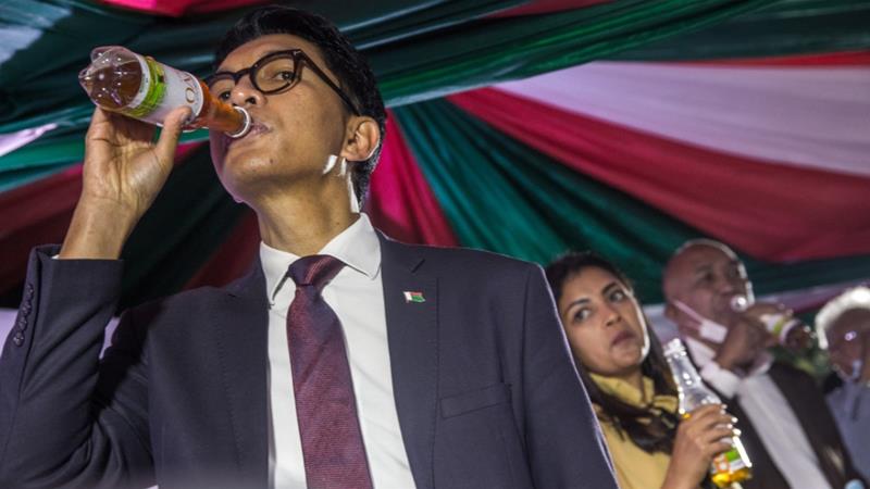 Madagascar's President Andry Rajoelina launched the purported concoction at a ceremony last month [Rijasolo/AFP]