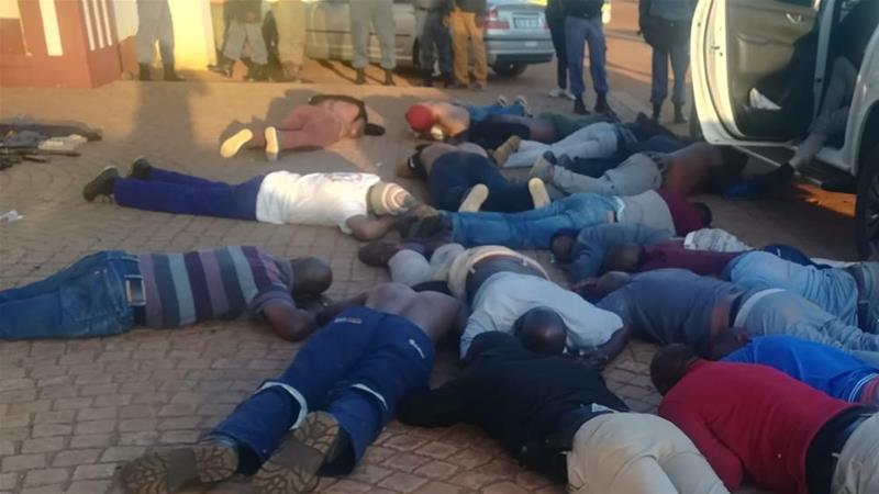 Photos tweeted by the police showed more than a dozen men lying on the ground, subdued [SAPS]
