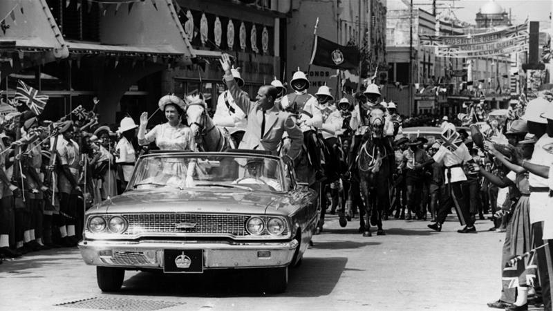 February 18, 1966: Queen Elizabeth and Prince Philip driving through Barbados waving to the crowds [File: Keystone/Getty Images]
