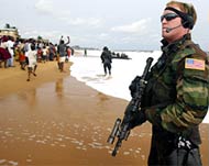 A US Marine disembarks on a Monrovia beach 