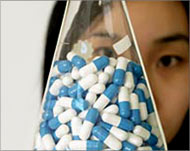 A Chinese laboratory worker shows drugs to fight aids 