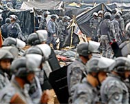 Anti-riot policemen destroy aHomeless Workers Movement tentencampment  last month 