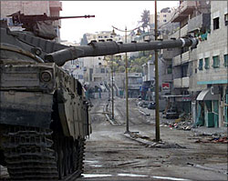 An Israeli tank points at a deserted street in the al-Azza refugee camp near Bethlehem.Israel consistently uses heavy weaponry andmilitary hardware in Palestinian towns.
