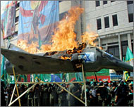 Palestinians burn a model of an Israeli F-16 warplane