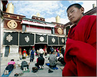 Tibetan pilgrims prostrate during prayers in Lhasa