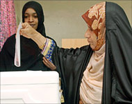 An Omani woman casts her vote at a polling station in Muscat 