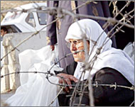 A Palestinian woman waits at an Israeli checkpoint near Nablus 
