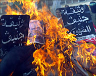 Hamas activists burn effigies of Beilin and Abd Rabbu during a West Bank demonstration