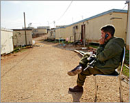 An Israeli soldier guards the illegal outpost of Givat Asaf near Ram Allah 