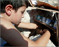 An Israeli child lights a candle at the site of the bomb blast in Haifa