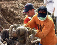 Emergency workers have found scores of victims buried in mud