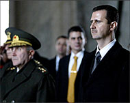 Syria's Bashar al-Asad (R) was invited to talks in Jerusalem