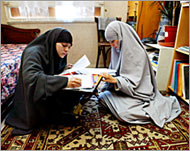 Alma Levy-Omari (L) and her sister Lila (R) study at home