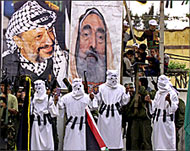 Protesters hold posters of Shaikh Yasin (R) killed by Israel in March
