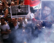 Iraqi protesters fill the streets and chant anti-US slogans 