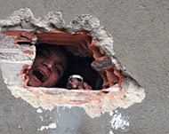An inmate shouts through a hole in the wall during the prison riot 