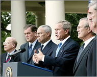 Bush (C) supports the idea of a limited national intelligence chief 