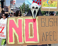 Protesters held banners against APEC and US President Bush
