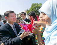 Thaksin's (L) bird drop comesweeks before a general election 