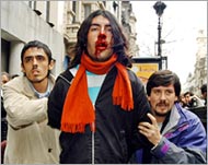 A man is bloodied in a protest in Buenos Aires over the IMF debt