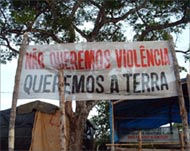 A peasants' banner says: We don't want violence we want land
