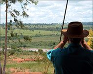 A farmer watches landlesspeasants on his land