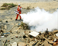 A South Korean aid worker usesdisinfectant in Galle, Sri Lanka