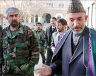 Dustum (L) ran and lost againstKarzai in the October election