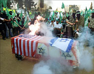 Israeli and US flags were drapedaround a mock coffin and burned